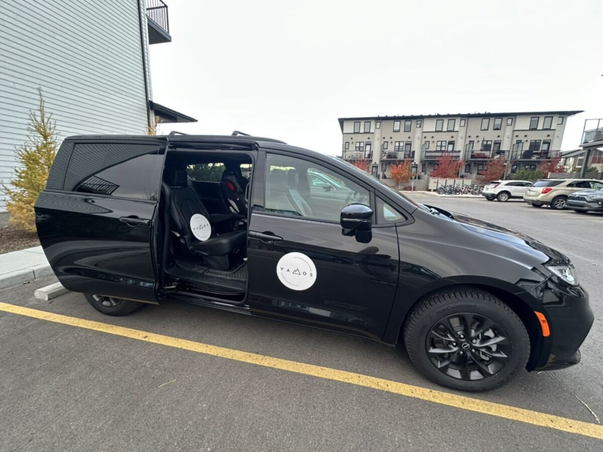 Vamos Express shuttle minivan with sliding doors open for easy boarding